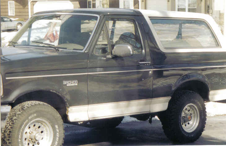 1993 Ford Bronco side view, dark body with white top and trim