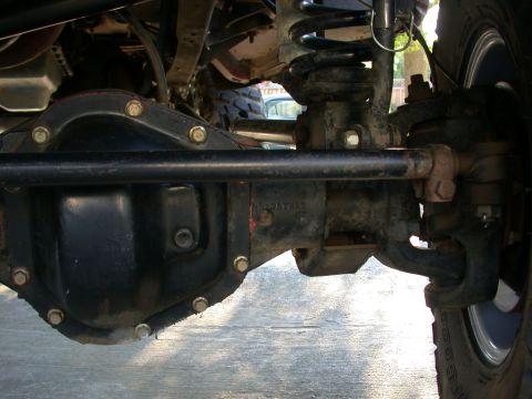 1996 Ford Bronco - Detailed view of the front axle and suspension system of an off-road vehicle.
