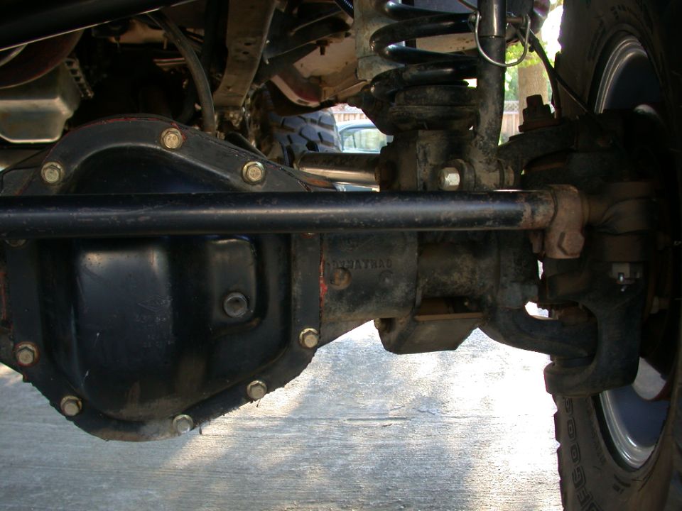 Close-up of a black differential housing and suspension components on a vehicle