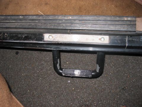 1988 Ford Bronco - Interior view of a vehicle's step, showing wear and tear on the black paint.