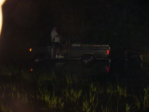 1989 Ford Bronco - Truck sits in dark water at night, with a person visible in the driver's seat.