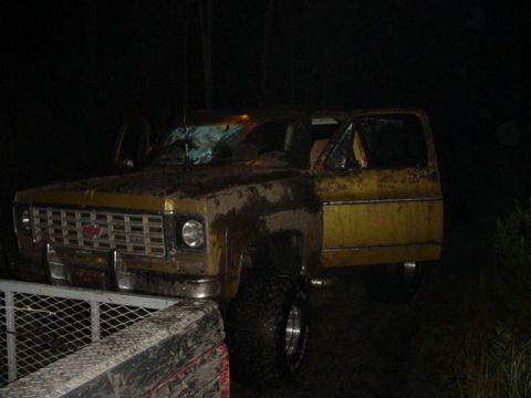 1989 Ford Bronco - This yellow SUV, likely from the mid-1970s, is shown at night with its doors ajar.