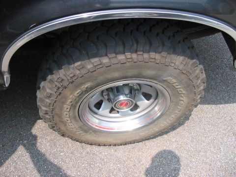 1988 Ford Bronco - This photo shows a close-up of a vehicle's off-road tire and wheel assembly.