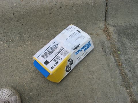 1988 Ford Bronco - A box labeled 'Superwinch Hubs' rests on a concrete surface.