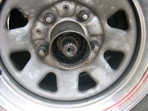 1988 Ford Bronco - A close-up view of a manual locking hub assembly on a vehicle's wheel.