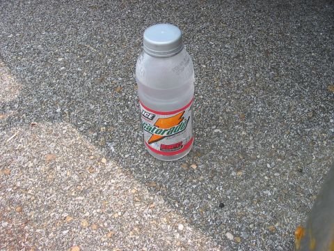 1988 Ford Bronco - A bottle of Gatorade sits on a gravel surface.