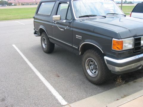 1988 Ford Bronco - 1988 Ford Bronco parked in a lot, viewed from the front three-quarter angle.