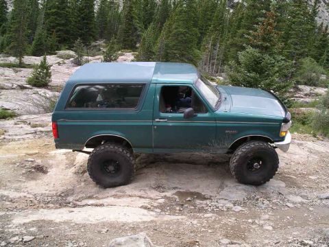 1996 Ford Bronco - 1996 Ford Bronco tackling rough terrain during an off-road adventure.