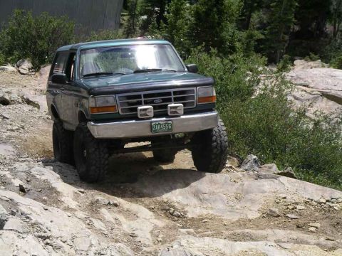 1996 Ford Bronco - This 1996 Ford Bronco navigates a challenging rocky path, its off-road capabilities.