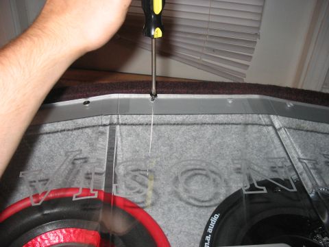 1988 Ford Bronco - Installing a custom speaker box in a vehicle, with text visible on the clear cover.