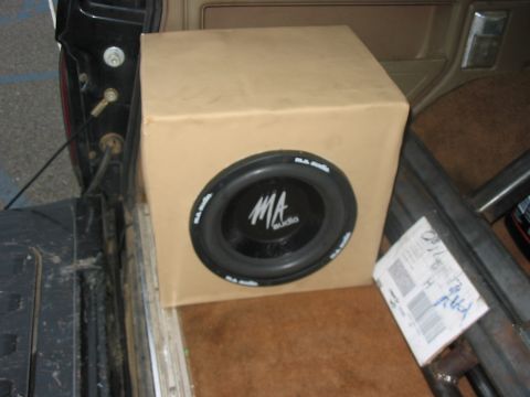 1988 Ford Bronco - A speaker box containing an MA audio subwoofer is visible in the cargo area of a vehicle.