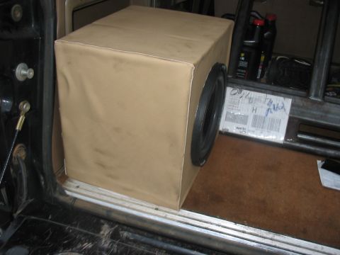 1988 Ford Bronco - A custom speaker box is installed in the cargo area of a vehicle, with other items visible in the background.