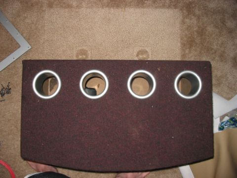 1988 Ford Bronco - A speaker box with four cup holders is shown on a carpeted surface.