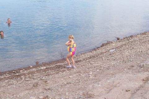 1992 Ford Bronco - Children enjoy a day at the lake, with two girls swimming and another standing on the shore.