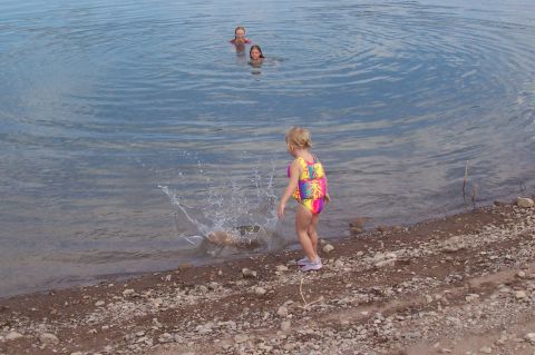 1992 Ford Bronco - A young girl enjoys a day at the lake, creating a splash as others swim nearby.