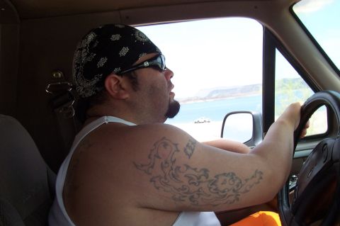 1992 Ford Bronco - Driver's perspective from inside a vehicle, with a lake and hills in the background.
