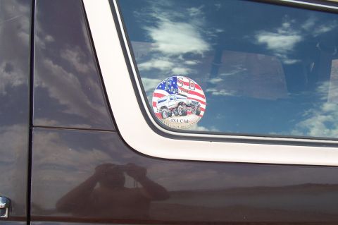 1992 Ford Bronco - Sticker on the window of a vehicle, depicting a 4x4 club logo with a truck and flag.