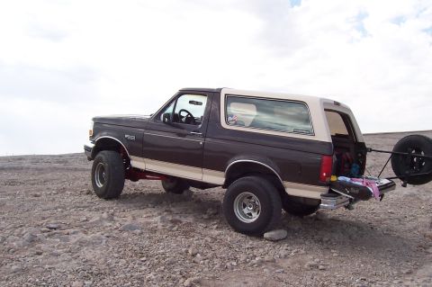 1992 Ford Bronco - This 1992 Ford Bronco is shown from a three-quarter front angle, parked in an outdoor, rocky environment.