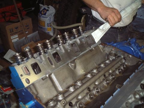 1967 Ford Galaxie - Removing duct tape from the intake side of the heads to prepare for the intake installation.