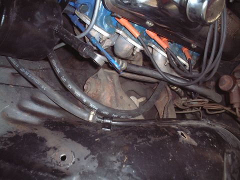 1967 Ford Galaxie - Close-up view of an engine bay with visible hoses and spark plug wires.