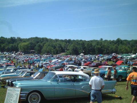 1967 Ford Galaxie - A 1958 Buick Limited is displayed at an outdoor car show with many other vehicles in the background.