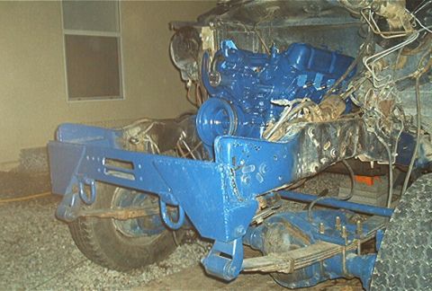 1986 Ford Bronco - Engine and chassis parts, painted blue, are visible in this close-up view.
