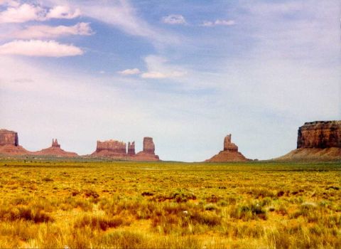 1996 Ford Bronco - A vast desert landscape with iconic rock formations under a partly cloudy sky.