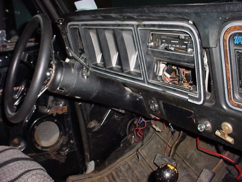 1979 Ford Bronco - The dashboard of an older vehicle shows exposed wiring and an empty radio slot, indicating it needs work.