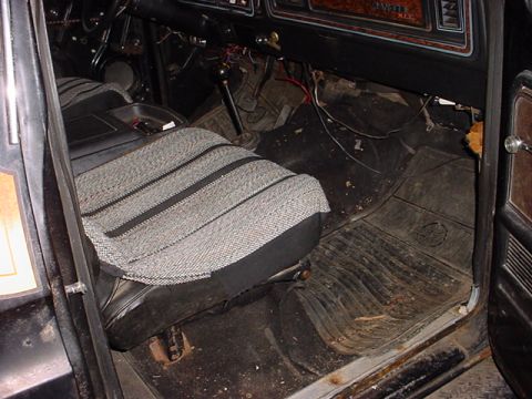 1979 Ford Bronco - The interior of a 1979 Ford Bronco reveals its age with worn seats and dusty floor mats, hinting at its operational status.