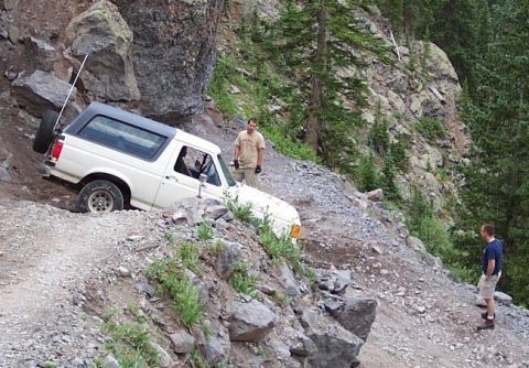 1990 Ford Bronco - This 1990 Ford Bronco is carefully maneuvering a challenging, steep, and rocky off-road path.
