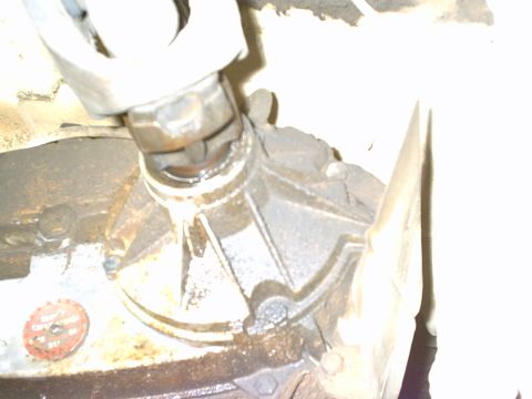 1984 Ford Bronco - Underside view of a vehicle's drivetrain components, focusing on the transfer case connection.