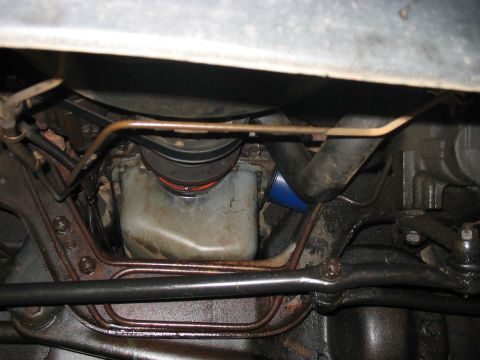 1988 Ford Bronco - Underside view of an engine oil pan and sway bar assembly, with a blue oil filter visible.