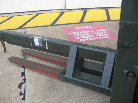1988 Ford Bronco - A forklift attachment is shown with a hazard warning sign in the background.