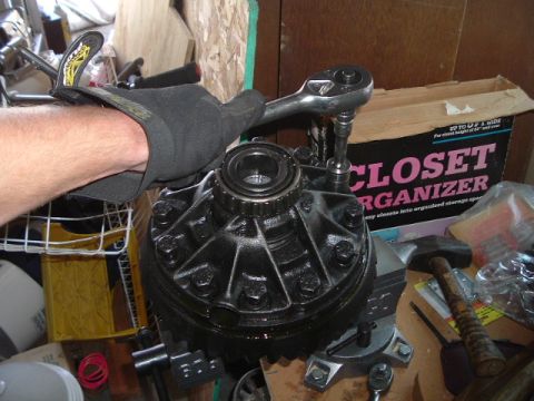 1989 Ford Bronco - Working on a differential assembly with a socket wrench in a garage setting.