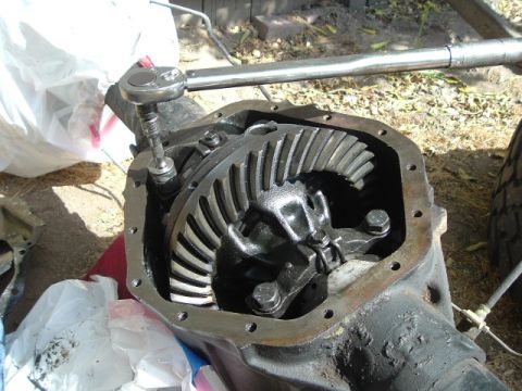 1989 Ford Bronco - Close-up of a vehicle's differential being worked on with a socket wrench.