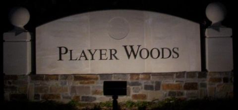 1989 Ford Bronco - A stone sign reading 'Player Woods' is illuminated at night, with brickwork at its base.