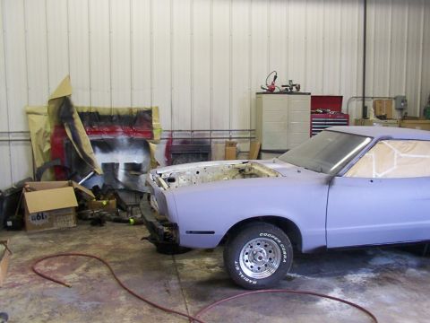 1978 Ford Mustang II - A 1978 Ford Mustang II is prepped for paint in a garage, showing its front quarter profile.