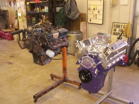 1978 Ford Mustang II - Two engines are displayed on stands in a workshop setting.