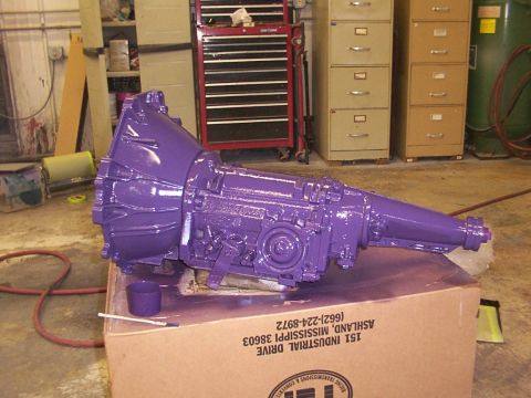 1978 Ford Mustang II - A freshly painted purple transmission sits on a box in a workshop setting.