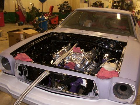 1978 Ford Mustang II - The engine bay of a car, possibly a 1975 model, is shown with the hood open and the engine partially visible.