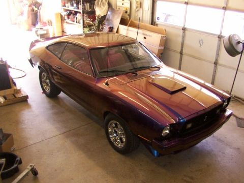 1978 Ford Mustang II - This car is a Ford Mustang II, likely from the mid-1970s, with a custom paint job and hood scoop.