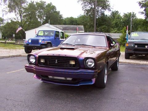 1978 Ford Mustang II - This iridescent coupe's body style is indicative of a mid-1970s vehicle, likely from around 1975.