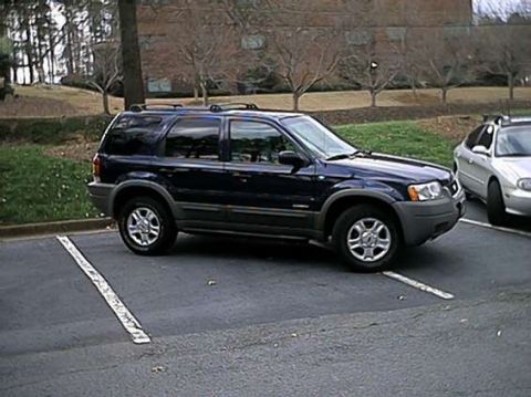 1998 Ford Taurus - This dark blue SUV is a 2001 Ford Escape, not a 1998 Ford Taurus.