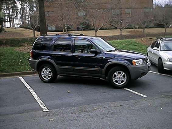 Dark blue 2001 Ford Escape parked in a lot, side view