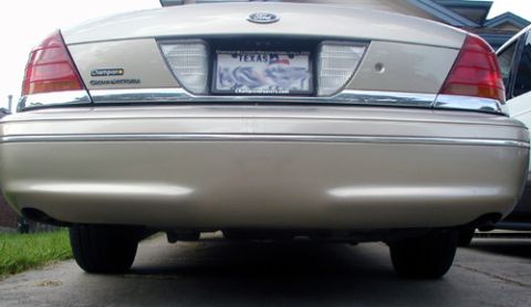 2000 Ford Crown Victoria - The rear of a tan Ford Crown Victoria is shown, its taillights and license plate.