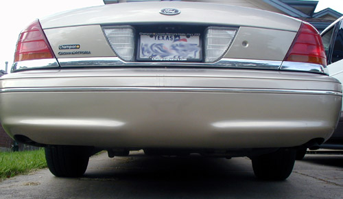 Rear view of a tan 2000 Ford Crown Victoria with a Texas license plate