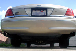 2000 Ford Crown Victoria - Rear view of a gold 2000 Ford Crown Victoria, highlighting its dual exhaust system and license plate.
