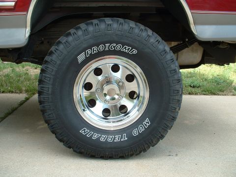 1994 Ford Bronco - This photo shows a close-up of a Pro Comp Mud Terrain tire and a chrome wheel on a vehicle.