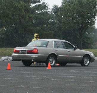 2001 Mercury Grand Marquis - A 2001 Mercury Grand Marquis is seen from the side, with orange cones on the asphalt.