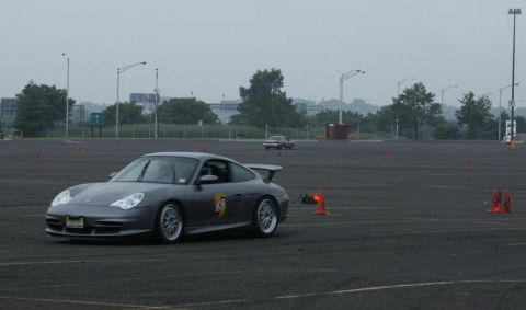 2001 Mercury Grand Marquis - Porsche 911 with racing decals navigates a course marked by orange cones.